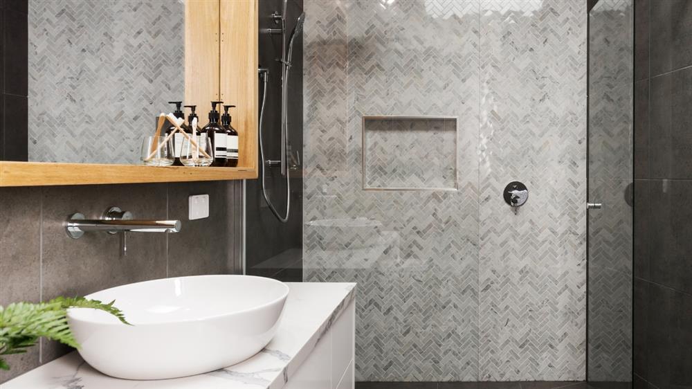 Modern bathroom with white vessel sink and walk-in shower